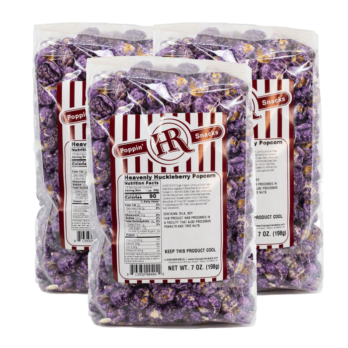 Three packages of HR Poppin' Snack Heavenly Huckleberry Popcorn on a white background