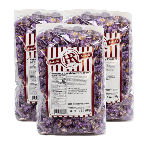 Three packages of HR Poppin' Snack Heavenly Huckleberry Popcorn on a white background