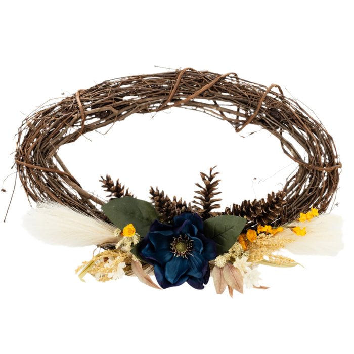A decorative wreath made of twigs and adorned with artificial blue and yellow flowers and beige accents.
