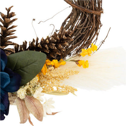 Details of a decorative wreath made of twigs and adorned with artificial blue and yellow flowers and beige accents.