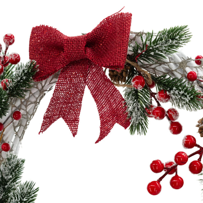 Red bow detail of a Christmas wreath made with white wires, green pine needles, red berries, and a red bow, crafted by KJ Made.