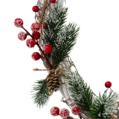 Berry and pine cone detail of a decorative Christmas wreath made with white wires, green pine needles, red berries, and a red bow, crafted by KJ Made.