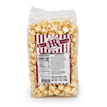 A clear plastic bag filled with popcorn, with a red and white striped label that includes the brand name 'HR Poppin' Snacks' and the product name 'Sweet Fire Popanero'.