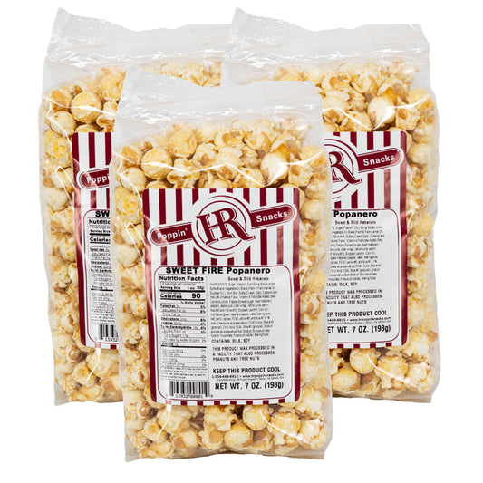 Three packages of sweet fire popanero popcorn with red and white labels on a white background.