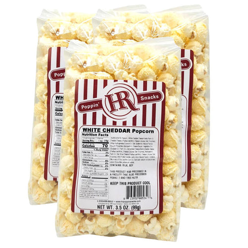 Three bags of white cheddar popcorn with an HR Poppin Snacks label on a white background.