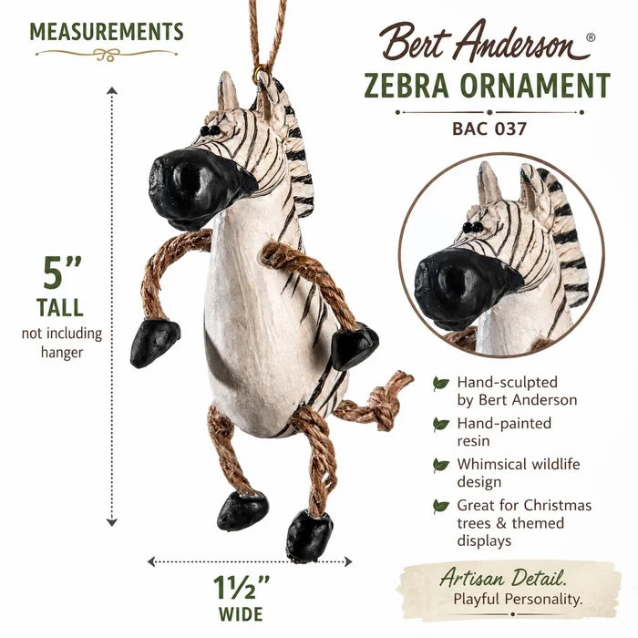 Bert Anderson Zebra Ornament product information graphic showing a hanging zebra ornament with dimensions labeled 5 tall and 1 1/2 wide, plus product features and a circular close-up inset on a white background.
